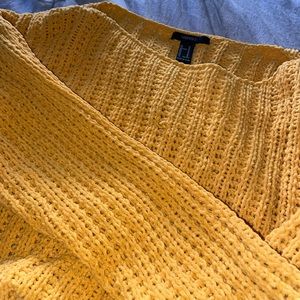 A knitted yellow Crewneck type of sweater